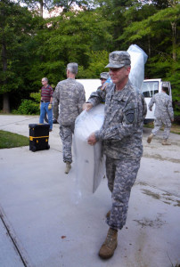 SFC Larry Long, 3BN/1BDE, carries a new mattress donated by the GSDF.